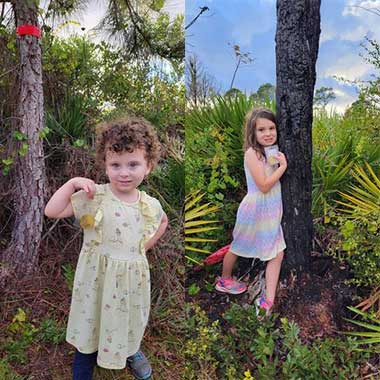 2 small girls holding up coins.