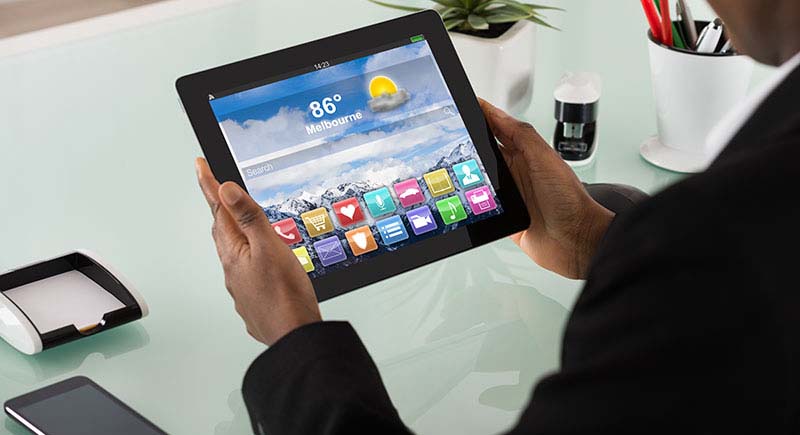 Person looking at weather forecast on a tablet.