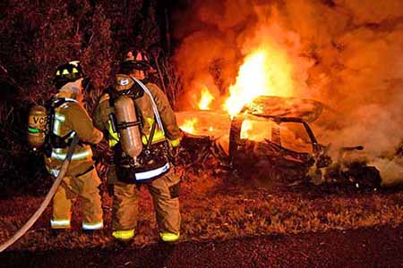 Firefighters and car fire