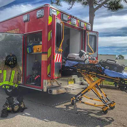 Fire Rescue Vehicle Emergency medical personel helping downed citizen.