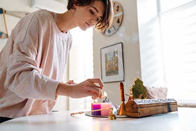 A woman lighting candles.