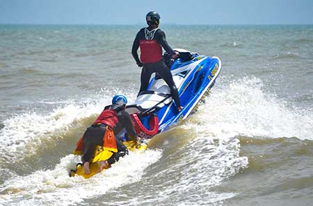 Lifeguards on jet ski. Two Ocean Rescue lifeguards riding on a jet ski in the ocean in Cocoa Beach.