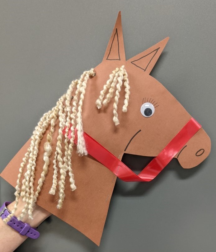 Paper horse puppet with yarn hair for the mane and ribbon for the reigns.