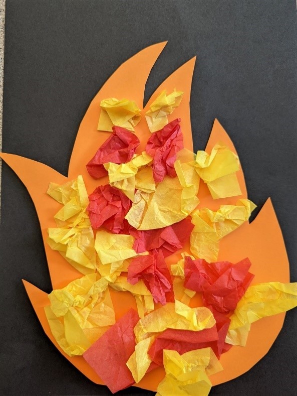 A fire craft made of various colors of construction paper and tissue paper.