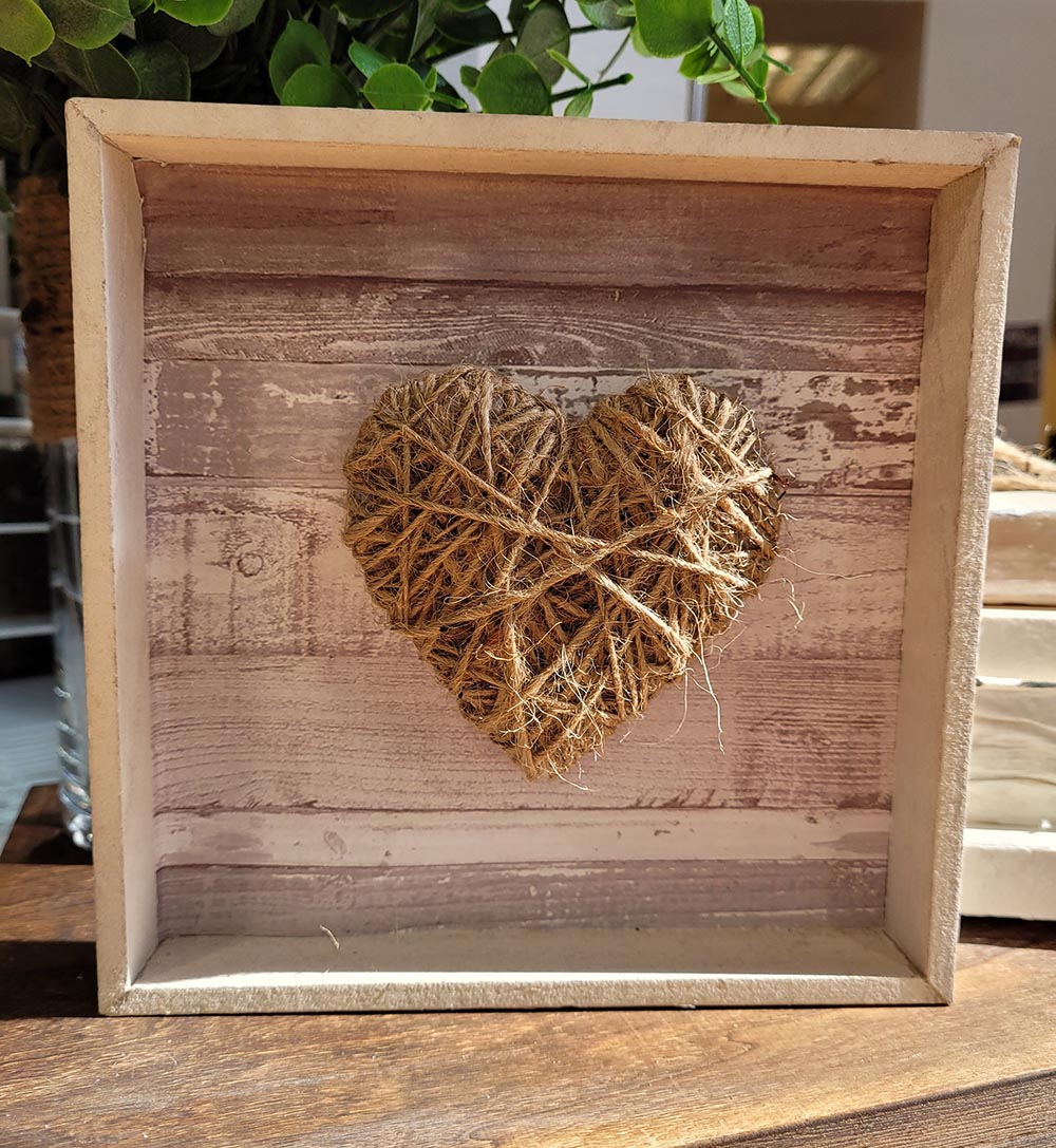 Twine crafted into the shape of a heart inside a shadow box.