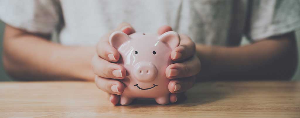 Piggy Bank Hands cupping a piggy bank.