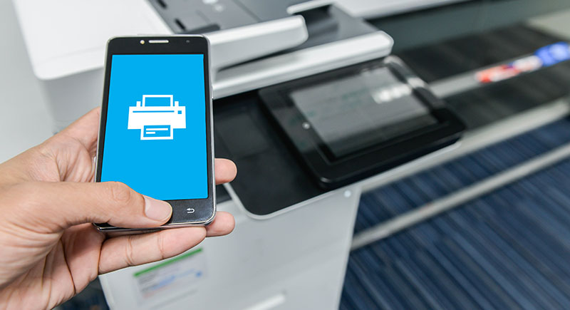 Wireless Printing Person printing a document from their phone.