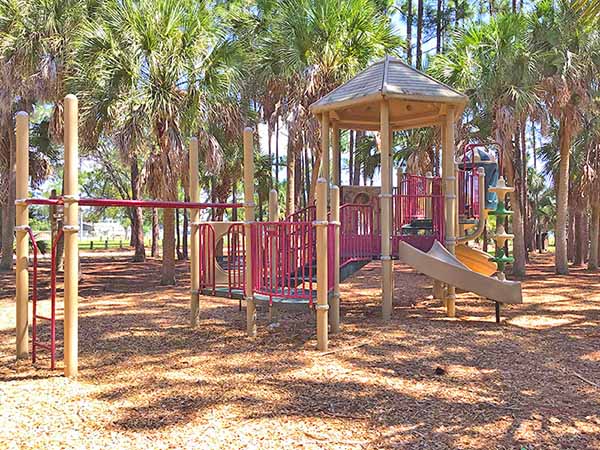 Playground area surrounded by trees   