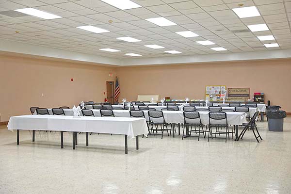 Tables and chairs set up in hall