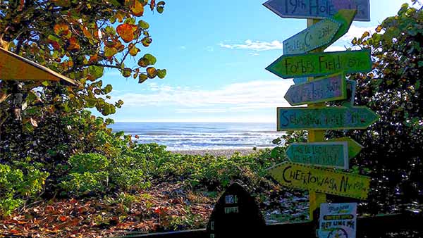 View of ocean with signs in foreground View of ocean with signs in foreground