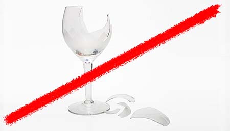 Line striking through broken wine glass