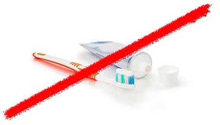 Line striking through tooth brush and tooth paste