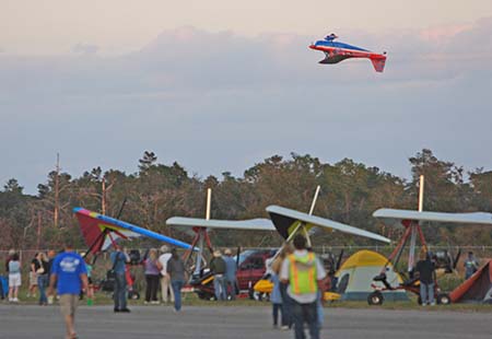 Airplane flying upside down at airshow.